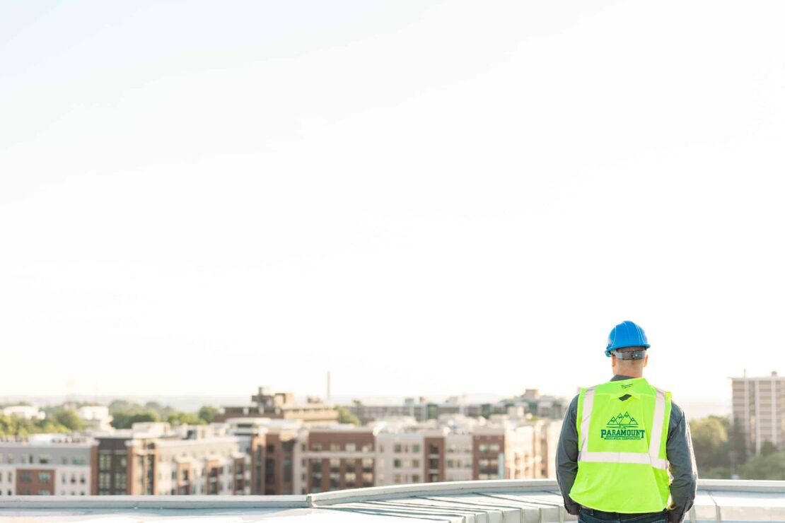 construction worker on top of a commercial building