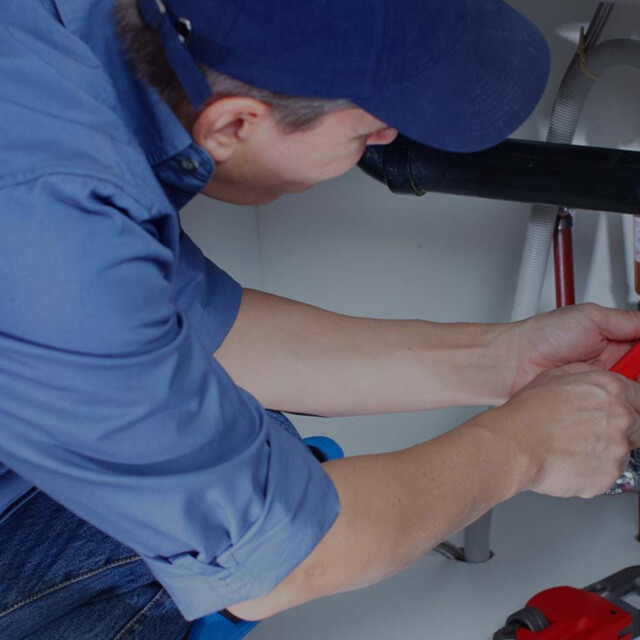 Man fixing plumbing.